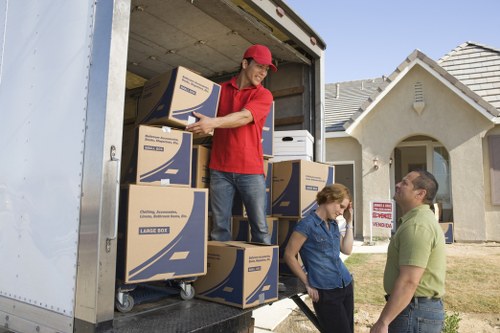 Staff separating cardboard, plastics, and reusable packing materials
